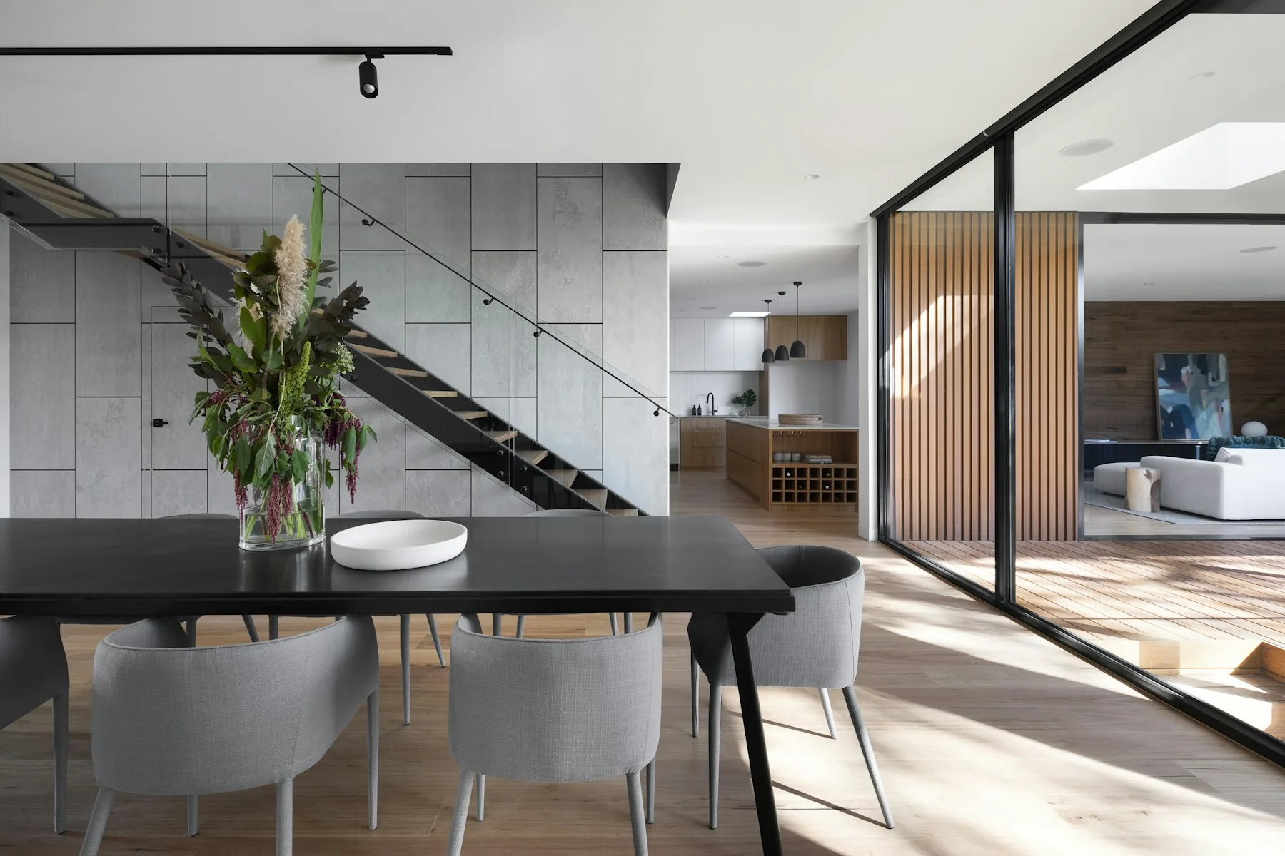 Contemporary interior with a sculptural staircase, timber finishes and natural daylight