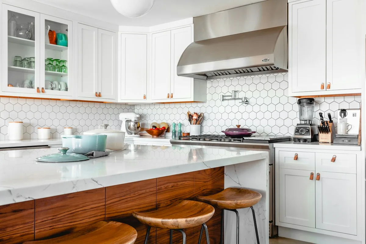 Kitchen with a timber island, white cabinetry and practical work surfaces